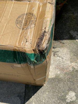 Same box smashed and showing dirt from being dropped.