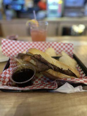 French Dip: Roast Beef and mozzarella cheese served on a hoagie roll with a side of Au Jus and Chips