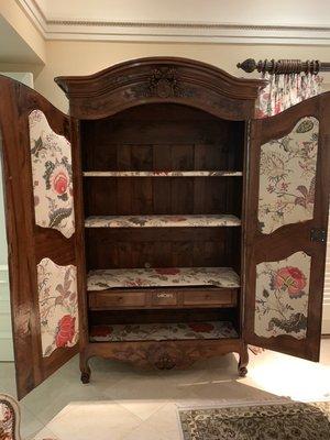 We redid an old armoire and added fabric to the shelves, drawers and inside of the doors.