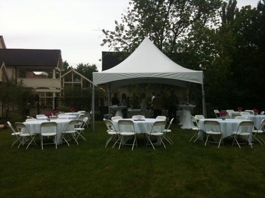 15x15 pinnacle frame tent with round tables, linens and white resin folding chairs