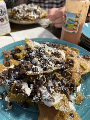 Chilaquillas smothered in salsa verde, beef, and beens. Queso Fresco on homemade tortilla chips! Fantastic!