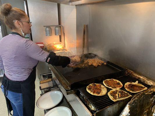 Ms. Loera getting the chorizo and asada for some Tacos ready Right now ! REMEMBER YOU ORDER WE MAKE NO REHEAT BS!