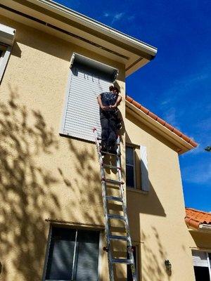 Our lead technician Sean installing rolling shutters on the second floor townhouse in Kendall, Miami