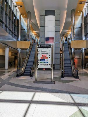 Inside the IAH Houston Rental Car Center. Elevators up to shuttles to airport terminals. Downstairs are rental car agencies.