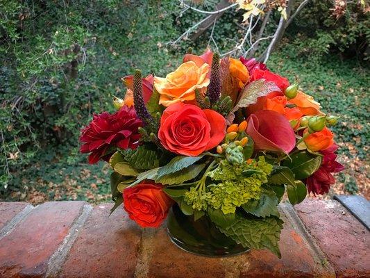 Colorful fall arrangement with roses and hydrangea.