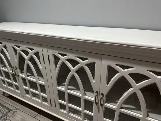 More of the white credenza with the squiggly line on the top it looks like somebody used Plato