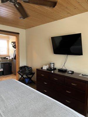 Flat screen and spacious dresser.