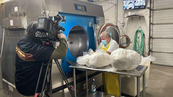 Tidee Didee sorting soiled diapers into the washer. (Feat. KOIN TV crew)