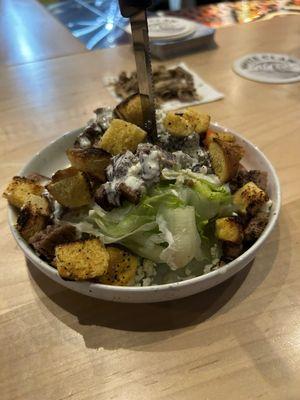 Wedge Salad with house made croutons and back , and slow smoked brisket.