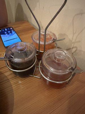 Sauces on the table (hoisin, chili, fish sauce)