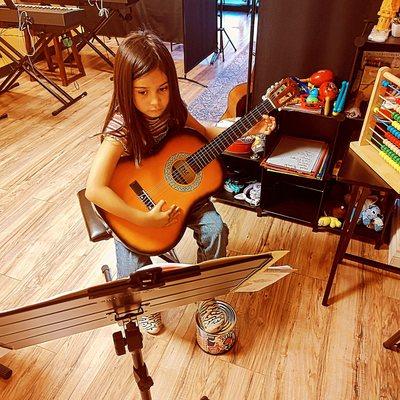 Young guitar student.