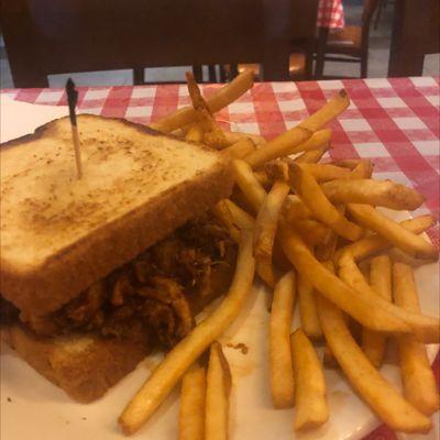 Texas Pulled Pork Sandwich with fries.