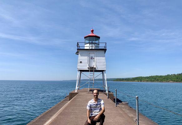 Taking a photo with this old fashioned lighthouse surrounded by Lake Superior.