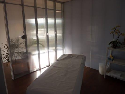 One of our treatment rooms. We love how we have transparent walls that allow natural light to come in while you are treated!