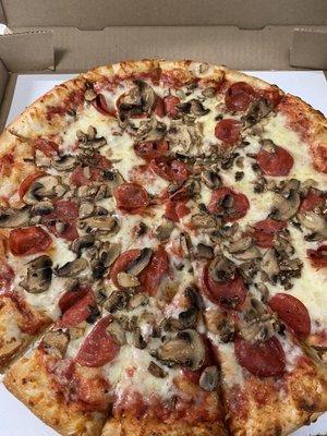 Large round cheese pizza with pepperoni and mushrooms