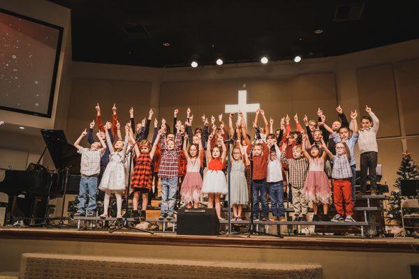 Children's ministry family Christmas choir performance singing traditional songs.