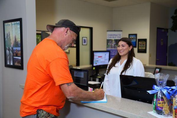 Our front desk Chiropractic Assistant, Karen, with one of our patients.