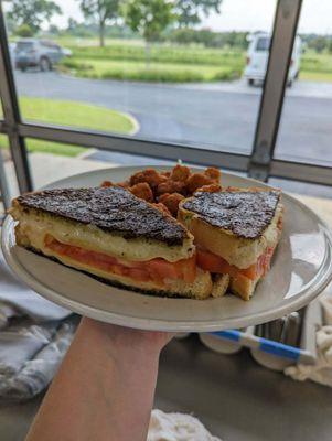 Our Lunch special for today is a kale pesto-crusted grilled cheese. Melty Mozzarella and Gouda paired with an heirloom tomato on sourdough.