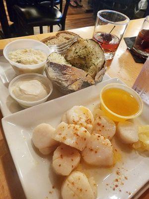 Sauteed scallop meal with baked potato