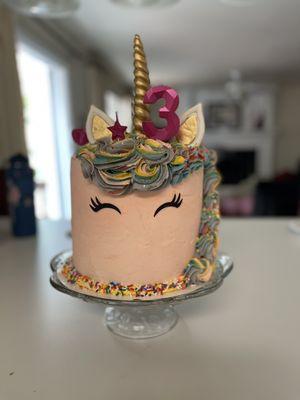 Unicorn cake. 8" cake, three layers, dense white moist cake with strawberry mousse in between, and butter cream frosting.