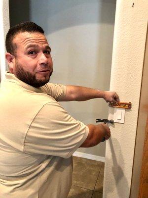 Jesus ensuring that not only id the switch plate attached, but it is level as well showing that he cares about the finished job.