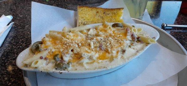 Southwest Mac & Cheese with added in chicken, and a slice of garlic bread.