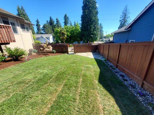 Full lawn renovation, beds and flat stone patio and pathways.