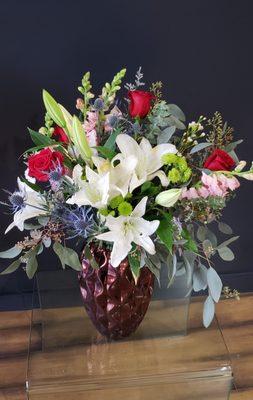 Beautiful ceramic vase brings that perfect touch to these flowers.