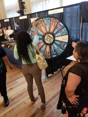 Mel. R spins the Channel 10 wheel as Rachel looks on..