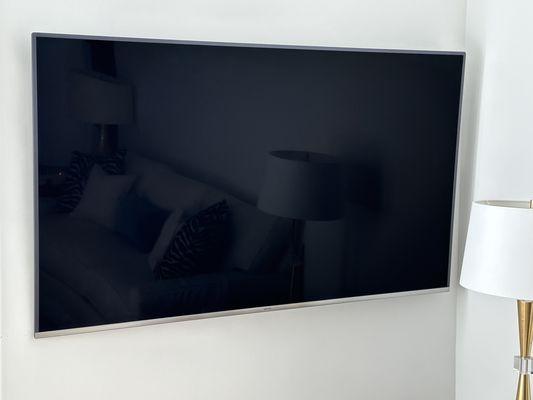 75" TV Mounted on a curved wall.