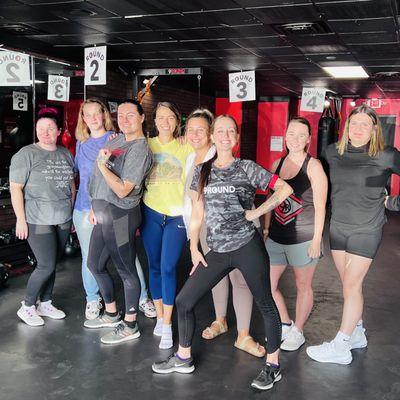 A group of ladies pose with owner & coach "Right Hook" Rikki after finishing a killer 9ROUND Kickboxing Fitness workout together!