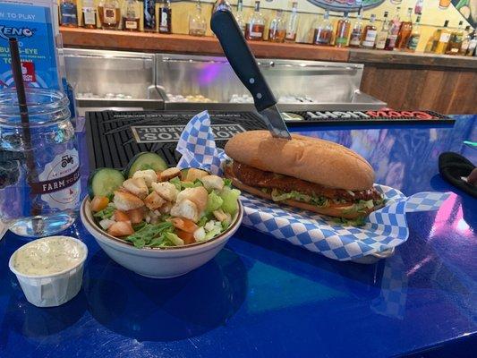 Buffalo chicken sandwich with a side salad