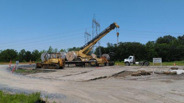 Big machines hoisting towers.