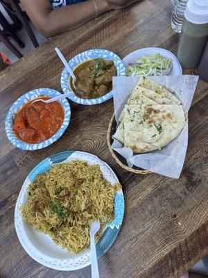 Lamb biriyani, chicken tikka masala, goat curry, and garlic naan