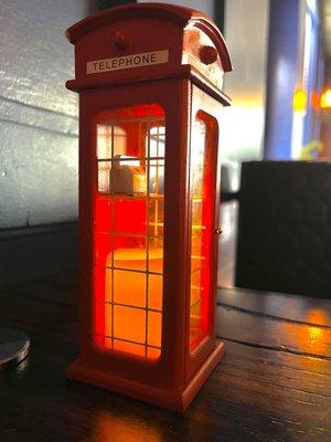 Cute phone booth with an LED candle inside. All of the tables had them.