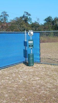 A lonely poop bag dispenser and trash can