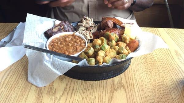 Joe's platter... Pulled pork, ribs, wings, fried okra, baked beans and hush puppies. Great food! Yum!