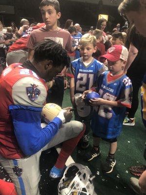 Players signing autographs.