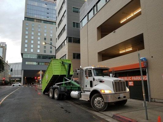 Greenwaste of Sacramento delivering a dumpster in Downtown Sacramento.