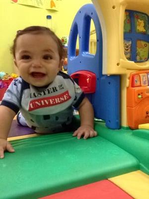 Gianni is crawling through the play house strengthening his back muscles while having fun.