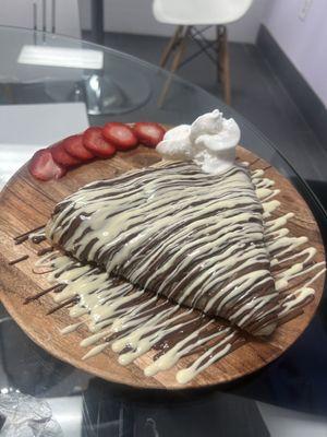 Banana and strawberry stuffed crepe with Nutella and Belgian white chocolate drizzle.