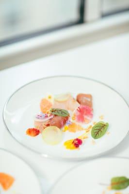 Cured yellowtail with pink grapefruit, jamon iberico, lemon puree, and watermelon radish