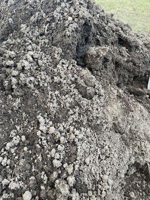 Rocky fill dirt sold as top soil