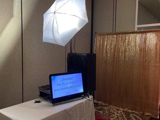 Open air Booth with gold sparkle backdrop.