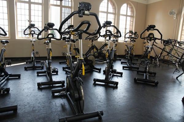 Group Cycling Studio -- classes offered throughout the week, with a majectic view of Downtown though uniquely arched windows