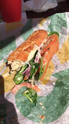 Rotisserie chicken sub, spinach, Caesar, tomato, red onion, provolone cheese. SO good