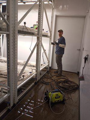 Pressure washing and hand scrubbing racks at a local farm. We do cleaning for home, business, and industrial sites like warehouses.