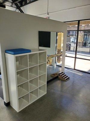 Organized cubicles for storage and a large mirror for therapeutic exercises