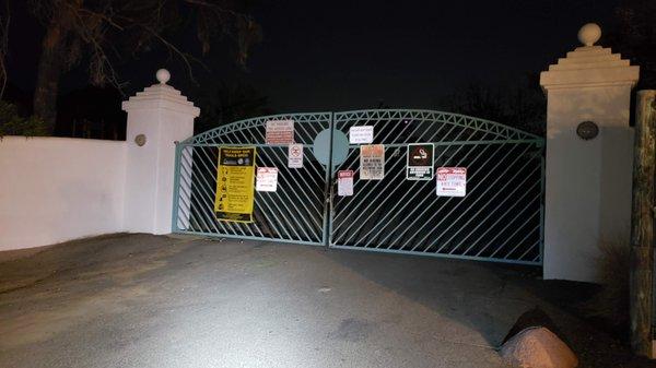 The gate that separates the residental area and path to the back of the sign