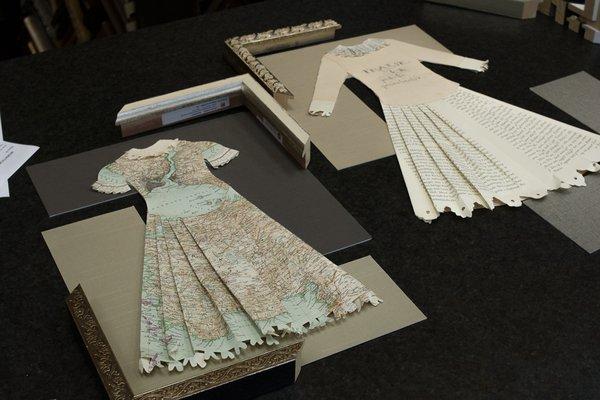 Dresses made of maps and old book pages.